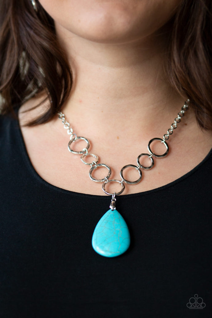 A collection of silver links give way to a refreshing turquoise stone teardrop, creating a tranquil pendant below the collar. Each silver ring is hammered in texture, adding an artisanal touch to the piece. Features an adjustable clasp closure.  Sold as one individual necklace. Includes one pair of matching earrings.  Always nickel and lead free.