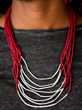 Load image into Gallery viewer, Infused with two large silver fittings, shiny red seed beads are threaded along countless strands, creating dramatic layers below the collar. Shimmery silver accents slide along the centers of the strands, adding depth and shimmer to the seasonal palette. Features an adjustable clasp closure.  Sold as one individual necklace. Includes one pair of matching earrings.  