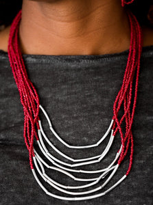 Infused with two large silver fittings, shiny red seed beads are threaded along countless strands, creating dramatic layers below the collar. Shimmery silver accents slide along the centers of the strands, adding depth and shimmer to the seasonal palette. Features an adjustable clasp closure.  Sold as one individual necklace. Includes one pair of matching earrings.  