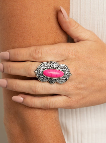 Embossed in lotus, sunset, and bold tribal inspired details, a scalloped silver frame nestles around a vivacious pink stone center for a colorful seasonal flair. Features a stretchy band for a flexible fit.  Sold as one individual ring.