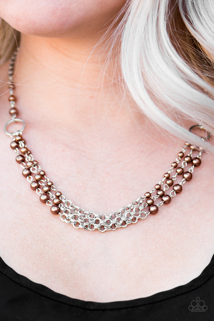 Gradually increasing in size, dainty brown pearls trickle along three rows of shimmery silver chain, creating refined layers below the collar. Features an adjustable clasp closure.  Sold as one individual necklace. Includes one pair of matching earrings.  Always nickel and lead free.