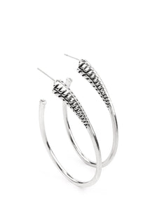  A spiral of texture resembling a coil anchors an exaggerated oblong silver hoop that wraps around the ear. The high-sheen finish on the curved bar adds a hint of drama, as it refracts the light in a knockout finish. Earring attaches to a standard post fitting. Hoop measures approximately 1 1/2" in diameter.