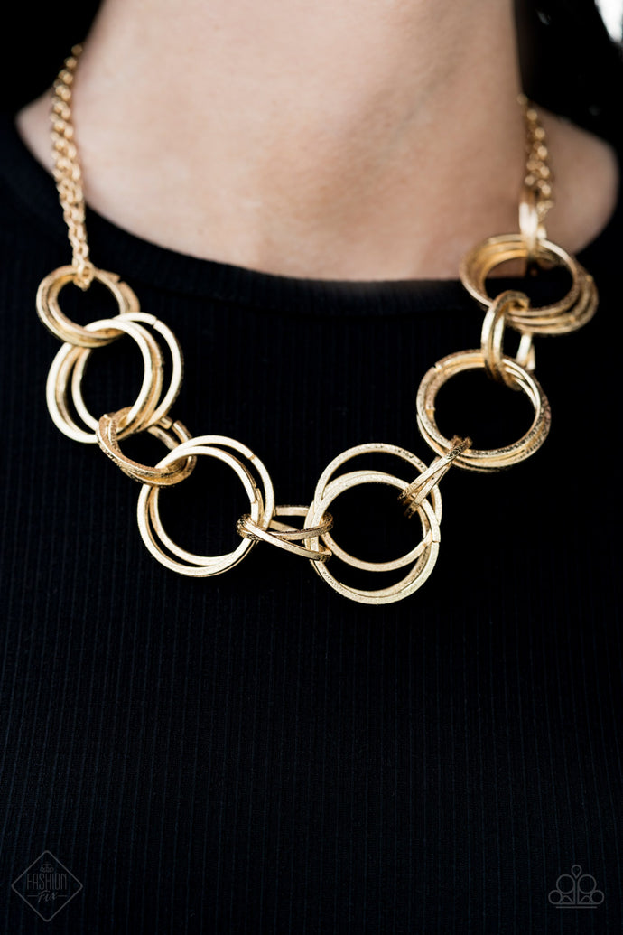 Delicately hammered in hints of shimmer, doubled and tripled gold hoops link below the collar for a bold industrial look. Features an adjustable clasp closure.  Sold as one individual necklace. Includes one pair of matching earrings.