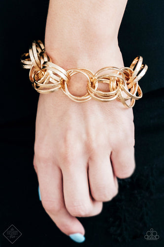 Etched in light-catching shimmer, glistening gold rings link around the wrist, connecting into a bold clustered fringe for a fierce industrial look. Features an adjustable clasp closure.  Sold as one individual bracelet.