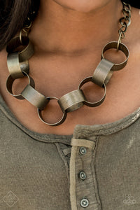  Etched in linear patterns, dramatically over sized brass links interlock below the collar, building into a bold statement-making piece. Features an adjustable clasp closure.