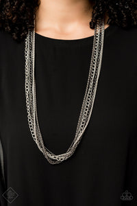 A chaotic mix of popcorn, classic, and dainty chains stream down the chest in an industrial masterpiece. The alternating finishes of shiny silver and glistening gunmetal adds miles of attitude to the design, resulting in an edgy collision of mixed metallic shimmer. Features an adjustable clasp closure.