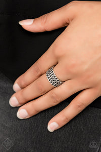Three row of shimmery silver chains links stack across the finger, coalescing into an edgy layered band. Features a stretchy band for a flexible fit.