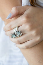Load image into Gallery viewer, Featuring ornate, shimmery silver, and white rhinestone encrusted petals, a pair of dainty blossoms bloom from glowing blue moonstone centers for a whimsical look. Features a stretchy band for a flexible fit.  Sold as one individual ring.  Always nickel and lead free.