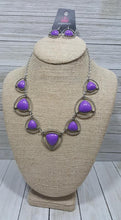 Load image into Gallery viewer, Bubbly purple beads pressed into sleek triangular silver frames link together to form a vivacious statement piece that beautifully cascades down the chest. Features an adjustable clasp closure.  Sold as one individual necklace. Includes one pair of matching earrings.  Exclusive