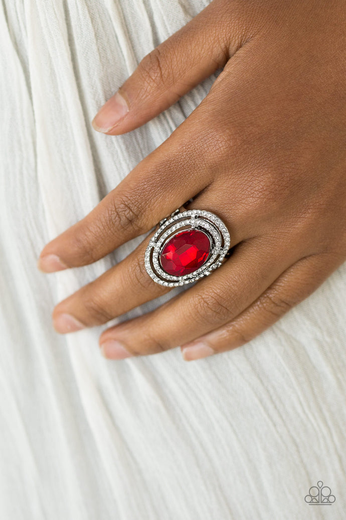 A glittery red gem sits atop stacked silver frames radiating with glassy white rhinestones for a timeless look. Features a stretchy band for a flexible fit.  Sold as one individual ring.