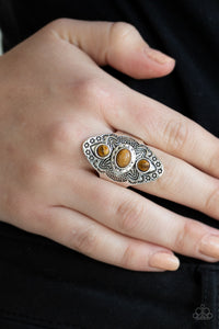Stamped and studded in tribal inspired patterns, a thick silver frame folds around the finger. Glassy tiger's eye stones are pressed down the ornate frame for a colorful finish. Features a stretchy band for a flexible fit.  Sold as one individual ring.  Always nickel and lead free.