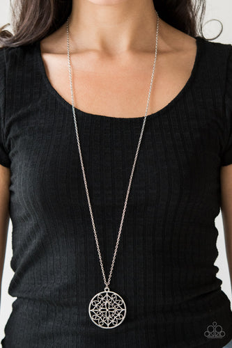 Featuring a whimsical mandala pattern, a glistening silver pendant swings from the bottom of a lengthened silver chain for a seasonal look. Features an adjustable clasp closure.  Sold as one individual necklace. Includes one pair of matching earrings.  Always nickel and lead free.