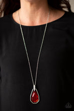 Load image into Gallery viewer, A dramatically oversized red gem and edgy silver frame swing from a glassy white rhinestone fitting at the bottom of a lengthened silver chain for a glamorous look. Features an adjustable clasp closure.  Featured inside The Preview at ONE Life!   Sold as one individual necklace. Includes one pair of matching earrings.   Always nickel and lead free.