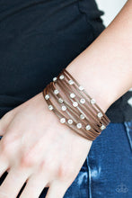 Load image into Gallery viewer, A brown leather band has been spliced into skinny strands. Glittery white rhinestones are haphazardly sprinkled across the bands, scattering shimmer across the wrist. Features an adjustable snap closure.  Sold as one individual bracelet.  Always nickel and lead free.