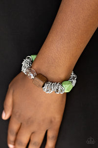 A mishmash of bold silver chain, refreshing green stones, a square wooden bead and metallic and crystal-like accents are threaded along a stretchy elastic band for a seasonal look.  Sold as one individual bracelet.  Always nickel and lead free.