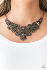 Embossed in whimsical floral detail, antiqued brass and copper plates connect below the collar for a statement making look. Features an adjustable clasp closure.  Sold as one individual necklace. Includes one pair of matching earrings.  Always nickel and lead free.