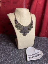 Load image into Gallery viewer, Embossed in whimsical floral detail, antiqued brass and copper plates connect below the collar for a statement making look. Features an adjustable clasp closure.  Sold as one individual necklace. Includes one pair of matching earrings.  Always nickel and lead free.