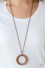 Load image into Gallery viewer, Featuring a hammered finish, a collection of interlocking copper hoops are threaded through the center of textured copper fittings. The dizzying pendant swings from the bottom of a lengthened copper chain for a dramatic industrial look. Features an adjustable clasp closure.  Sold as one individual necklace. Includes one pair of matching earrings.