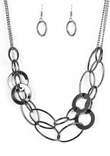 Load image into Gallery viewer, Mismatched gunmetal rings and hoops link below the collar in bold layers for a spunky industrial look. Features an adjustable clasp closure.  Sold as one individual necklace. Includes one pair of matching earrings.