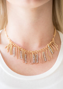 Threaded along metallic rods, stacks of smoky beading trickle from the bottom of a gold chain. The glittery accents trickle between trestles of gold chains, creating a fierce fringe below the collar. Features an adjustable clasp closure.  Sold as one individual necklace. Includes one pair of matching earrings.  