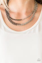 Load image into Gallery viewer, Strung between two gunmetal fittings, glistening gunmetal chains collide with shimmery silver chains below the collar, creating edgy mixed metallic layers. Features an adjustable clasp closure.  Sold as one individual necklace. Includes one pair of matching earrings.   Always nickel and lead free.