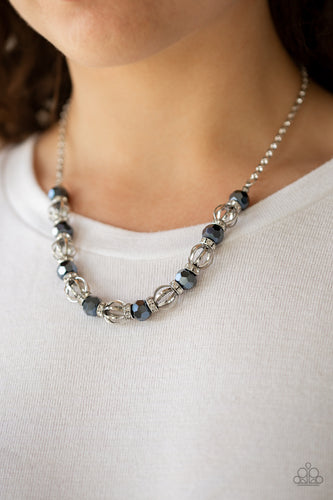 A collection of airy silver beads, faceted blue metallic beads, and white rhinestone encrusted rings are threaded along an invisible wire below the collar for a statement-making fashion. Features an adjustable clasp closure.  Sold as one individual necklace. Includes one pair of matching earrings.  Always nickel and lead free.