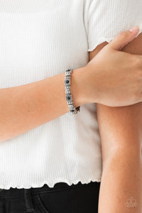 Infused with black rhinestone centers, ornate silver frames are threaded along stretchy bands, creating a refined look around the wrist.  Sold as one individual bracelet.   Always nickel and lead free.