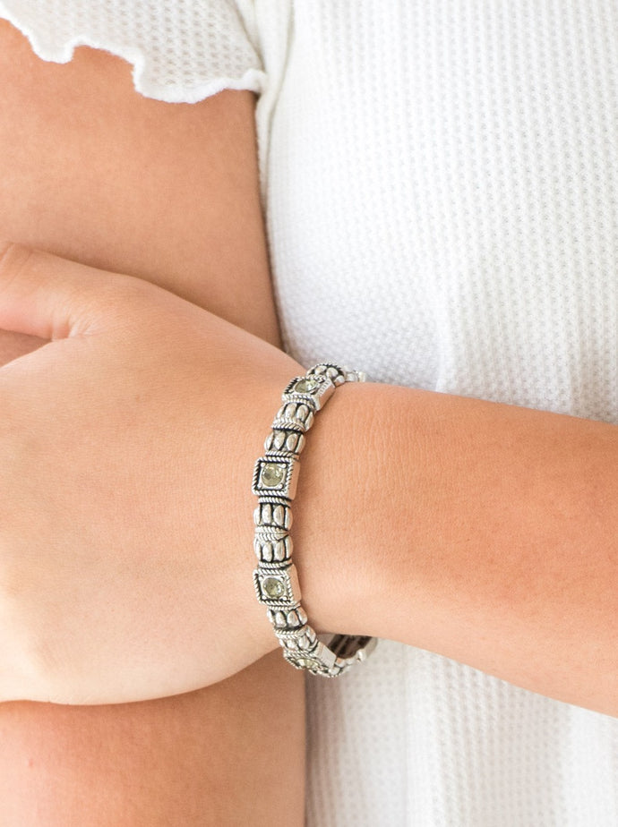 Infused with smoky rhinestone centers, ornate silver frames are threaded along stretchy bands, creating a refined look around the wrist.  Sold as one individual bracelet.  
