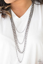 Load image into Gallery viewer, A mishmash of gunmetal chains drape across the chest for a collision of edgy textures. Features an adjustable clasp closure.  Sold as one individual necklace. Includes one pair of matching earrings.