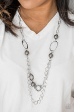 Load image into Gallery viewer, Dramatic gunmetal accents trickle along bold silver chains, creating an edgy mixed metallic palette across the chest. Features an adjustable clasp closure.  Sold as one individual necklace. Includes one pair of matching earrings.