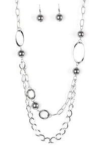 Dramatic gunmetal accents trickle along bold silver chains, creating an edgy mixed metallic palette across the chest. Features an adjustable clasp closure.  Sold as one individual necklace. Includes one pair of matching earrings.