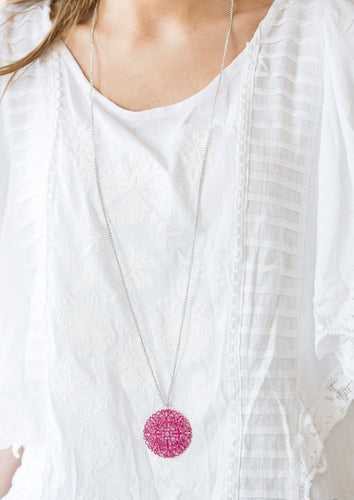 Brushed in a flirty Pink Peacock finish, a filigree filled pendant swings from the bottom of a lengthened silver chain for a seasonal look. Features an adjustable clasp closure.  Sold as one individual necklace. Includes one pair of matching earrings.