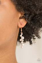 Load image into Gallery viewer, Varying in size, glittery white rhinestones tumble from the ear, coalescing into a magnificent lure. Earring attaches to a standard fishhook fitting.  Sold as one pair of earrings.  Always nickel and lead free.