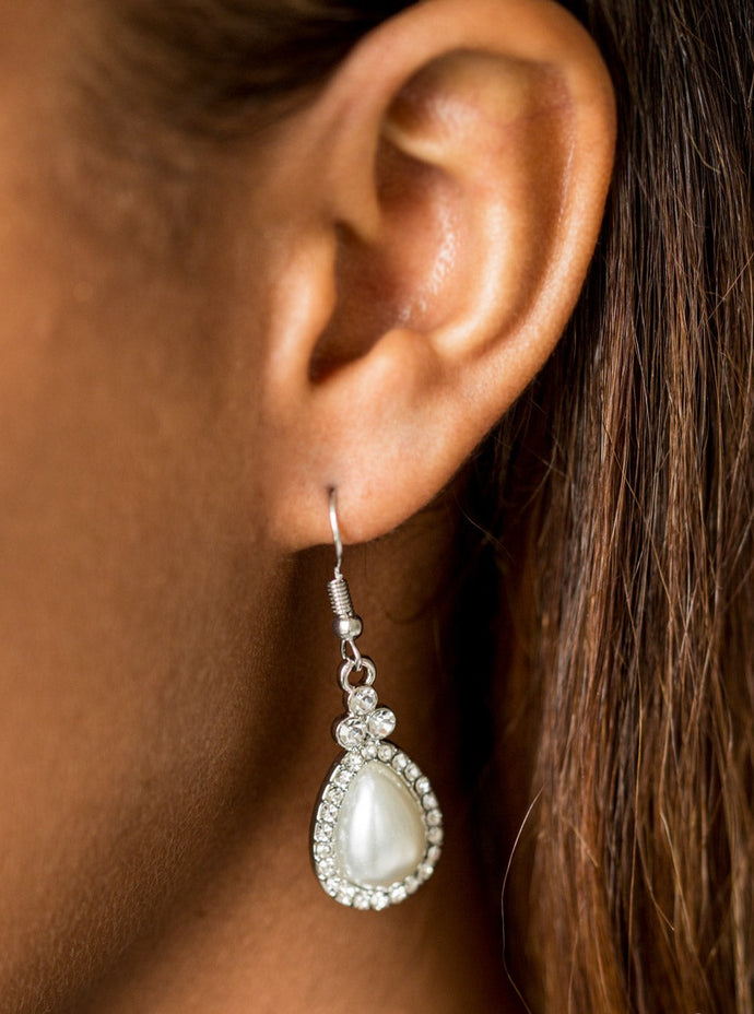 A pearly white teardrop bead is pressed into a white rhinestone encrusted frame, creating a timeless lure. Earring attaches to a standard fishhook fitting.  Sold as one pair of earrings.  