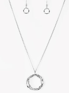 Twirling silver hoops swing from the bottom of an elegantly elongated silver chain, creating a dizzying pendant. Features an adjustable clasp closure.  Sold as one individual necklace. Includes one pair of matching earrings.