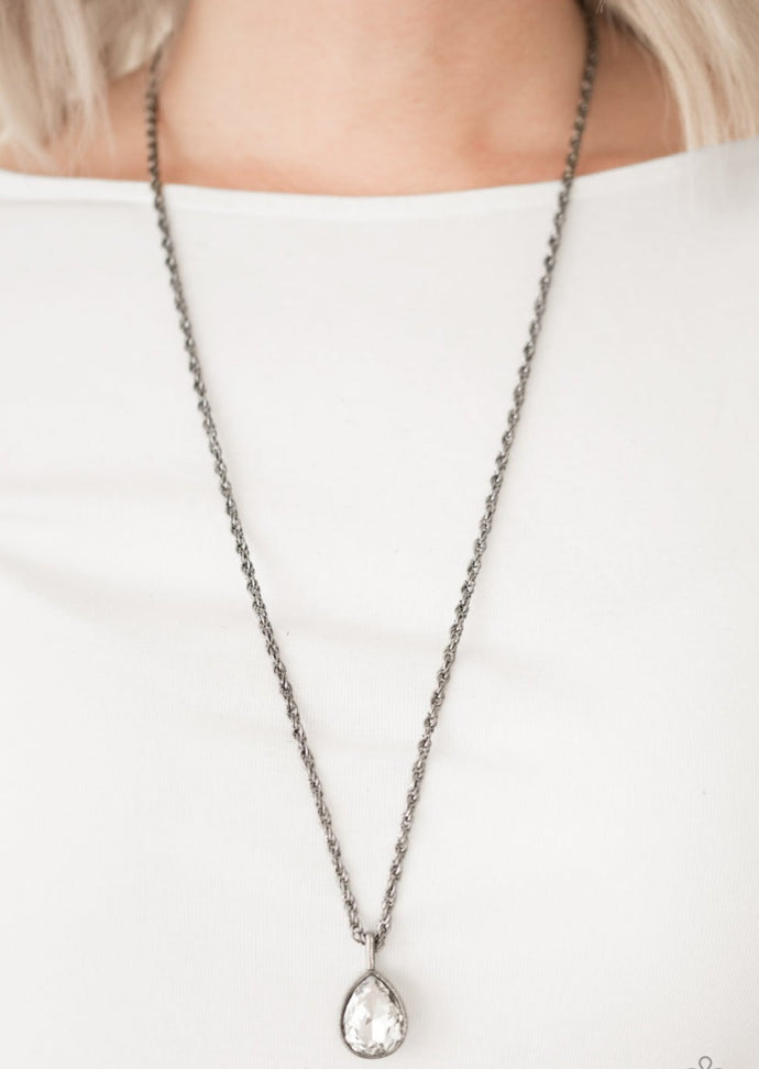 A white teardrop gem is pressed into a sleek gunmetal frame, creating a bold 3-dimensional pendant below the collar. Features an adjustable clasp closure.  Sold as one individual necklace. Includes one pair of matching earrings.