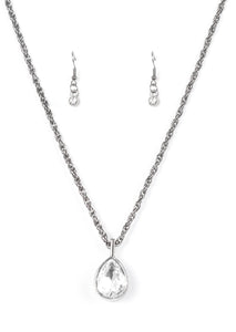 A white teardrop gem is pressed into a sleek gunmetal frame, creating a bold 3-dimensional pendant below the collar. Features an adjustable clasp closure.  Sold as one individual necklace. Includes one pair of matching earrings.