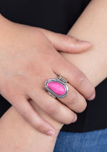Load image into Gallery viewer, A vivacious pink bead is pressed into the center of an airy silver band for a summery look. Features an elastic stretchy band for a flexible fit.  Sold as one individual ring.  