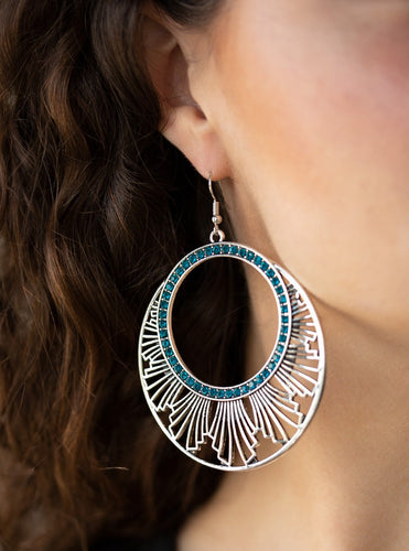An airy geometric fringe flares out from the bottom of a ring of glittery blue rhinestones for an edgy tribal look. Earring attaches to a standard fishhook fitting.  Sold as one pair of earrings.  