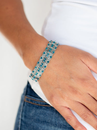 Encrusted in glittery blue rhinestones, ornately studded silver frames are threaded along stretchy bands for an edgy-glamorous look.  Sold as one individual bracelet.   