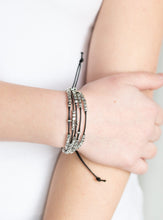 Load image into Gallery viewer, A collection of dainty silver beads and glistening silver cubes are threaded along strands of shiny black cording around the wrist for a minimalist inspired look. Features an adjustable sliding knot closure.  Sold as one individual bracelet.