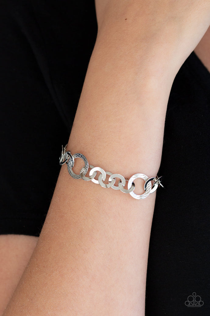 Smooth and textured silver hoops connect around the wrist for a modern industrial look. Features an adjustable clasp closure.  Sold as one individual bracelet.  Always nickel and lead free.