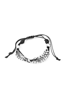 A collection of dainty silver beads and glistening silver cubes are threaded along strands of shiny black cording around the wrist for a minimalist inspired look. Features an adjustable sliding knot closure.  Sold as one individual bracelet.