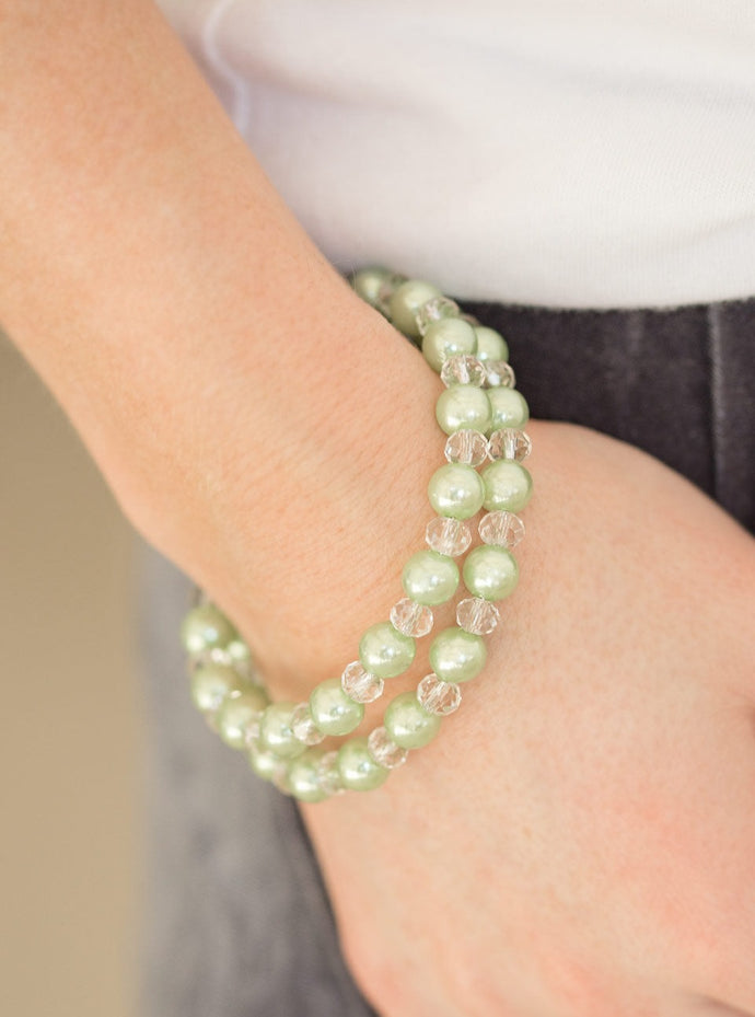 Classic green pearls and glittery crystal-like beads are threaded along a long wire to create an infinity wrap bracelet.  Sold as one individual bracelet.