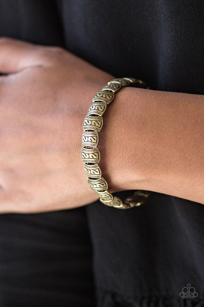 Embossed in tribal inspired patterns, dainty brass frames are threaded along a brass wire and wrapped around the wrist for a seasonal look. Features an adjustable clasp closure.  Sold as one individual bracelet.  Always nickel and lead free.