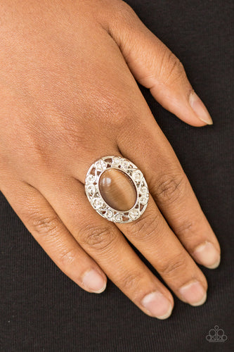 Shimmery floral-like filigree swirls around a glowing brown moonstone center, creating a whimsical centerpiece atop the finger. Features a stretchy band for a flexible fit.  Sold as one individual ring.  Always nickel and lead free.