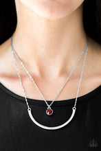 Load image into Gallery viewer, A red gem swings from the uppermost chain above a bowing silver bar. The shimmery layers flawlessly drape below the collar in a refined fashion. Features an adjustable clasp closure.  Sold as one individual necklace. Includes one pair of matching earrings.  Always nickel and lead free.