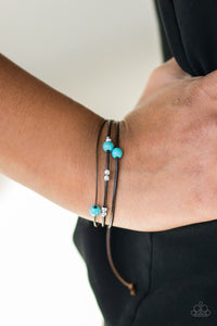 Shiny silver beads and refreshing turquoise stones are threaded along shiny black cording, creating dainty layers across the wrist. Features an adjustable sliding knot closure.  Sold as one individual bracelet.  Always nickel and lead free.