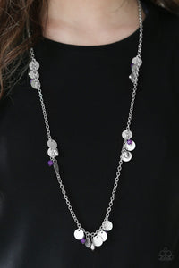Delicately hammered in blinding shimmer, glittery silver discs join purple crystal-like beading along a shiny silver chain for a whimsical look. Features an adjustable clasp closure.  Sold as one individual necklace. Includes one pair of matching earrings.  