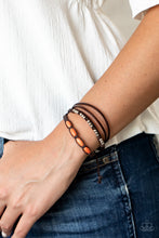 Load image into Gallery viewer, Infused with dainty silver and refreshing orange stone beads, mismatched strands of braided twine-like cord and brown leather pieces delicately layer across the wrist for a colorfully earthy look. Features an adjustable sliding knot closure.  Sold as one individual bracelet.  Always nickel and lead free.
